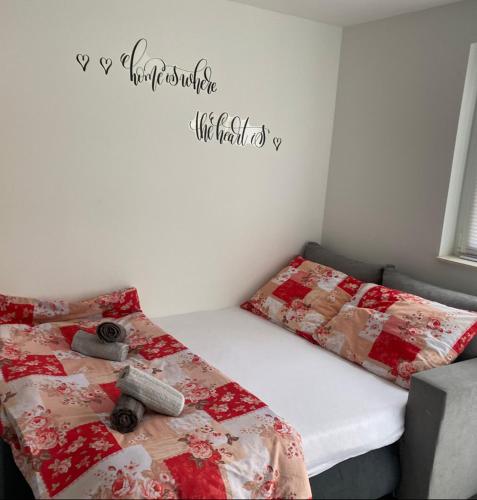 a bedroom with two beds and a sign on the wall at Studio apartment Carmen in Rubeši