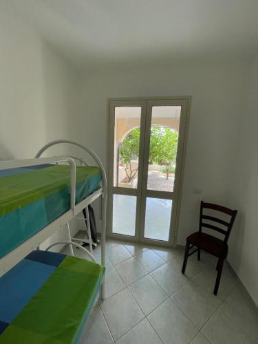 a hospital room with a bunk bed and a chair at Casa Cioppy in Cala Gonone