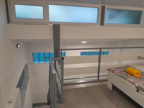 a room with a bunk bed and windows at Apartments Mare in Pula