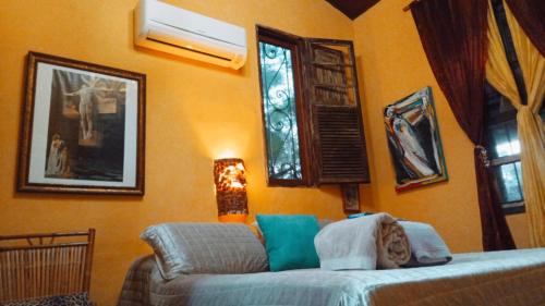 a living room with a couch and a window at Vila Santa Rosa Guest House in Ilhabela