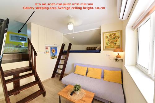 a small bedroom with a bunk bed and a ladder at Sweet Home, Only 7 Min to the beach - By SEAELO EILAT in Eilat
