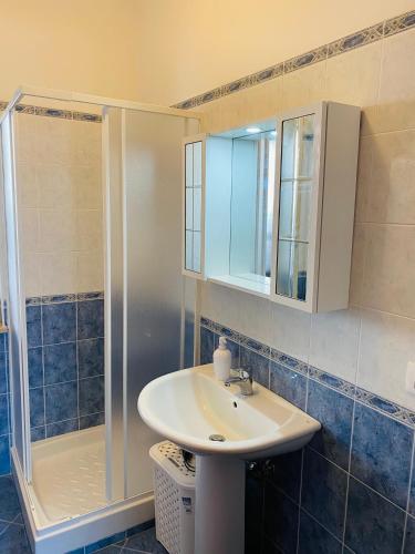 a bathroom with a sink and a shower at Marina Apartament in Scalea