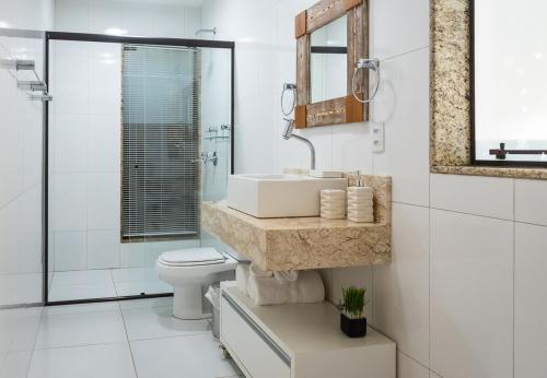 a bathroom with a sink and a toilet at Morada Prainha in Garopaba