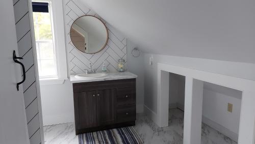 a bathroom with a sink and a mirror at Cozy Harbour House in Isaacs Harbour