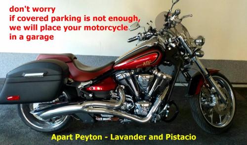 a red motorcycle parked in a garage at Apartmani Peyton in Slavonski Brod