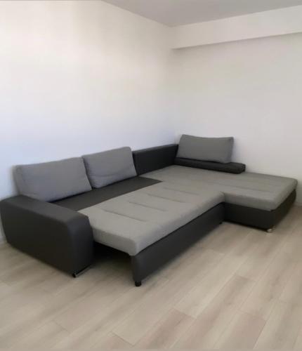 a black and gray couch in a room at 3M Apartment Skopje Center in Skopje