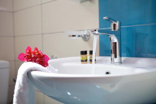 a bathroom sink with a towel and a faucet at Jimmy's House in Nikiana