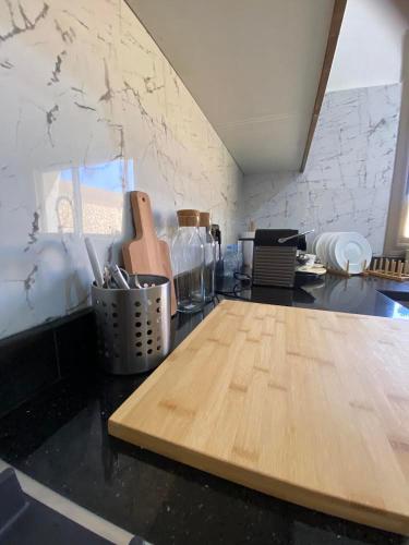 a kitchen with a wooden cutting board on a counter at Paradisiac and luxurious villa with private beach in Dakhla in Dakhla