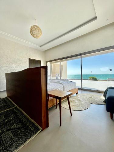 a bedroom with a bed and a view of the ocean at Paradisiac and luxurious villa with private beach in Dakhla in Dakhla