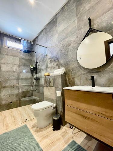a bathroom with a toilet and a sink and a mirror at Paradisiac and luxurious villa with private beach in Dakhla in Dakhla