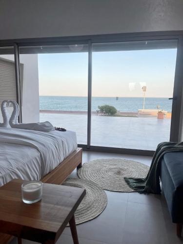 a bedroom with a bed and a view of the ocean at Paradisiac and luxurious villa with private beach in Dakhla in Dakhla