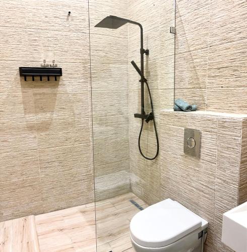 a bathroom with a shower with a toilet and a sink at Paradisiac and luxurious villa with private beach in Dakhla in Dakhla
