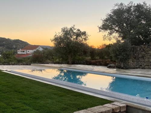 a swimming pool in the backyard of a house at Casas da Villa - Monsanto - Oliveira e Videira in Relva