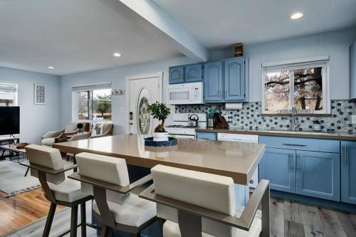 a kitchen with blue cabinets and a table and chairs at Sugar House Urban Basecamp in Salt Lake City