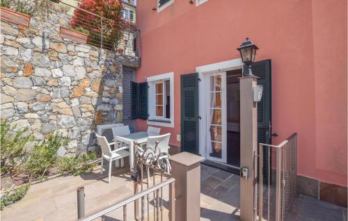 a patio with a table and chairs next to a building at Stunning Home In Magliolo in Magliolo