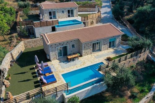 an aerial view of a house with a swimming pool at Villa di pietra II in Liapades