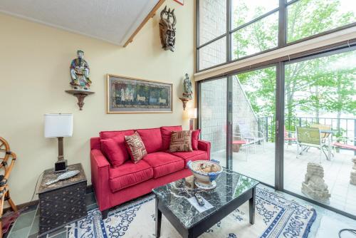 a living room with a red couch and a glass table at 307C One Bedroom One Bath in Oakland