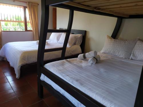 Llit o llits en una habitació de Cabañas Campestres Alcalá