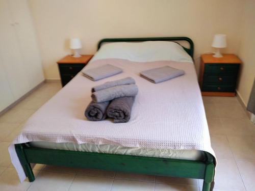 a bedroom with a bed with towels on it at Paphos town house vacation in Paphos City
