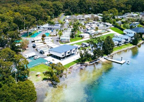 a large body of water with trees and houses at Jervis Bay Holiday Park in Huskisson