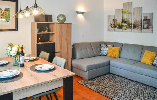 a living room with a couch and a table at 2 Bedroom Lovely Home In Vitrac in Vitrac
