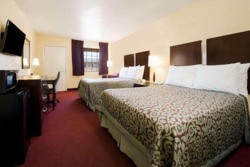 una camera d'albergo con 2 letti e una scrivania di Quality Inn a Eastland