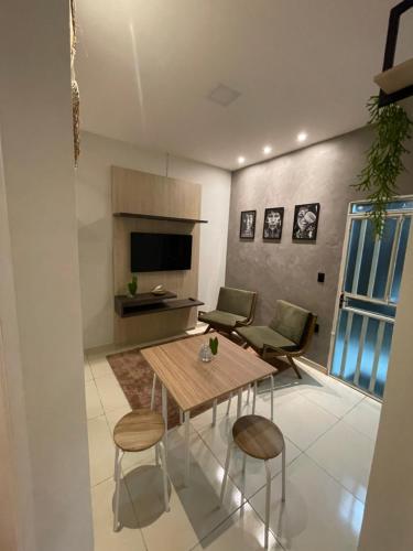 un soggiorno con tavolo e sedie in legno di Condomínio tranquilo a Boa Vista
