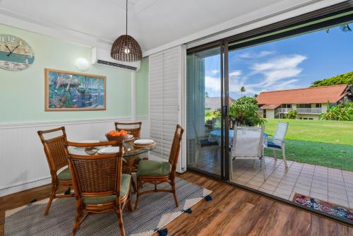 a dining room with a table and chairs at Quiet Kiahuna plantation , New Remodel with AC in Koloa