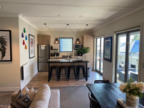 a kitchen with a table and a sink in a room at Cardrona Ski Apartment in Wanaka