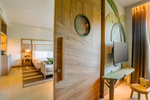 a room with a door leading to a bedroom at Holiday Inn Resort Samui Bophut Beach by IHG in Bophut 