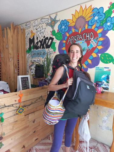 a girl is holding a bag in a room at Casa Apapacho hostel in San Cristóbal de Las Casas