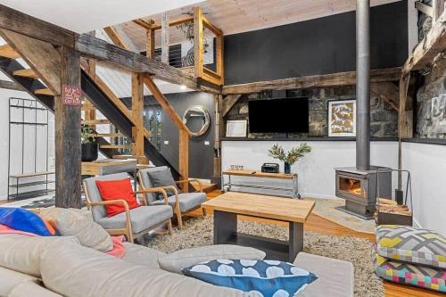 a living room with a couch and a fireplace at Woodlands Retreat in Ocean Grove