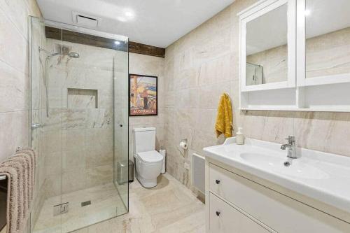 a bathroom with a shower and a sink and a toilet at Woodlands Retreat in Ocean Grove