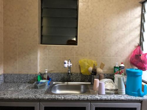 a kitchen counter with a sink and a mirror at A'Famosa Condo D'Savoy, Slumber Family Homestay Mslim guest only in Kampong Pulau Sebang