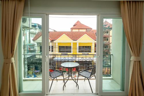 a view of a balcony with a table and chairs at Ivory Palace Hotel in Pattaya