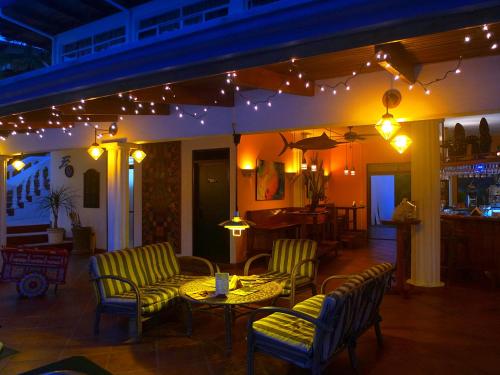 a restaurant with a table and chairs and lights at Cristal Ballena Boutique Hotel & Spa in Uvita
