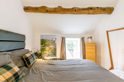 a bedroom with a bed and a window at Carr House Farm in Glossop