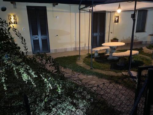 a patio with a table and an umbrella in a yard at Agriturismo San Michele in San Michele
