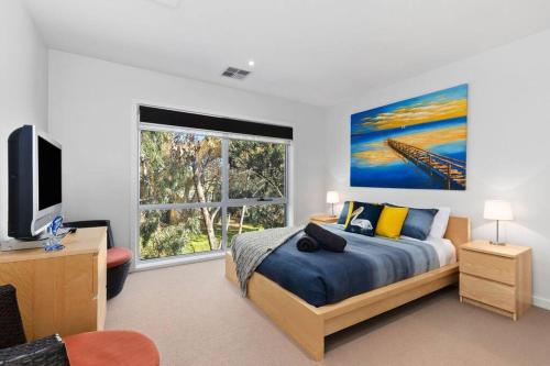 a bedroom with a bed and a large window at The Lake House in Ocean Grove