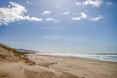 a sandy beach with the ocean in the background at The Beach Cabin MCA 736 - Meredith Lodging in Manzanita
