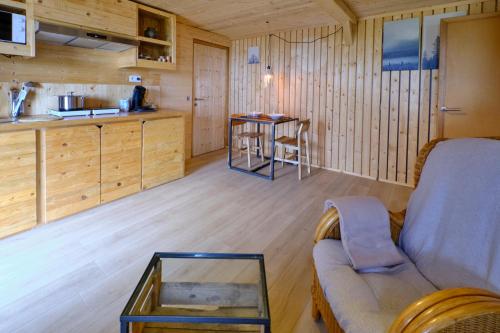 a living room with a couch and a table at La tanière in Chaudfontaine