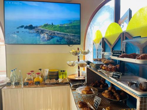 a bakery with pastries and breads on a counter at Hotel Boschetto in Follonica