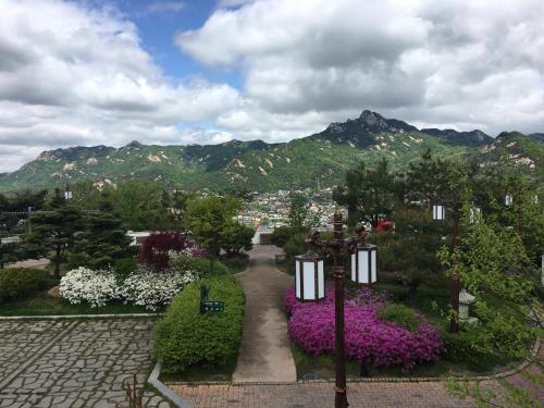 a view of a garden with flowers and a street light at Puzzlestay House in Seoul