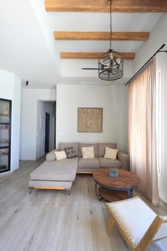 a living room with a couch and a table at Captains Villas & Suites in Apróvaton