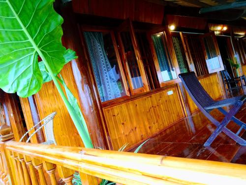 a chair sitting in front of a library with books at Surelee Homestay in Sa Pa