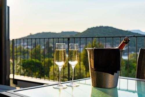 two glasses of champagne on a table on a balcony at Korcula Hill in Korčula