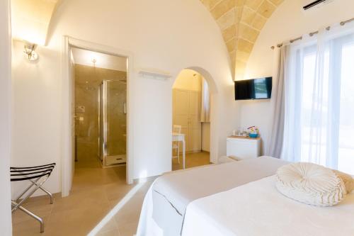 a bedroom with a white bed in a room at TENUTA DOROLIVO in Otranto