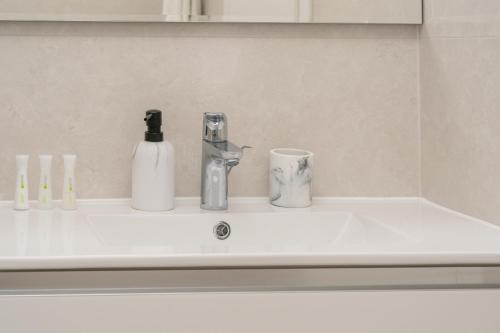 a sink with two bottles and a soap dispenser on it at Korcula Hill in Korčula