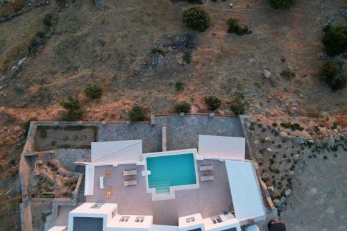 an aerial view of a house with a swimming pool at Captains Villas & Suites in Apróvaton