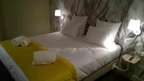 a bedroom with a bed with two towels on it at Aux Ateliers in Miserey-Salines